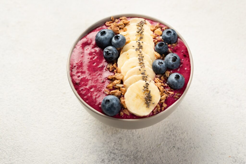 açai smoothie bowl with bananas and strawberries on top